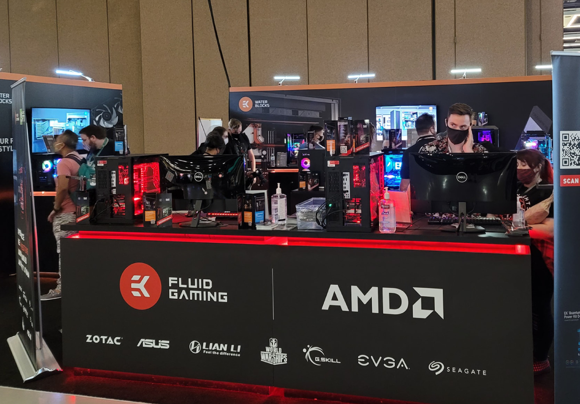 EK booth with a lineup of liquid-cooled PCs, AIOs, and builds