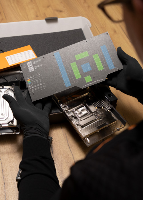 A hardware technician handling water block parts