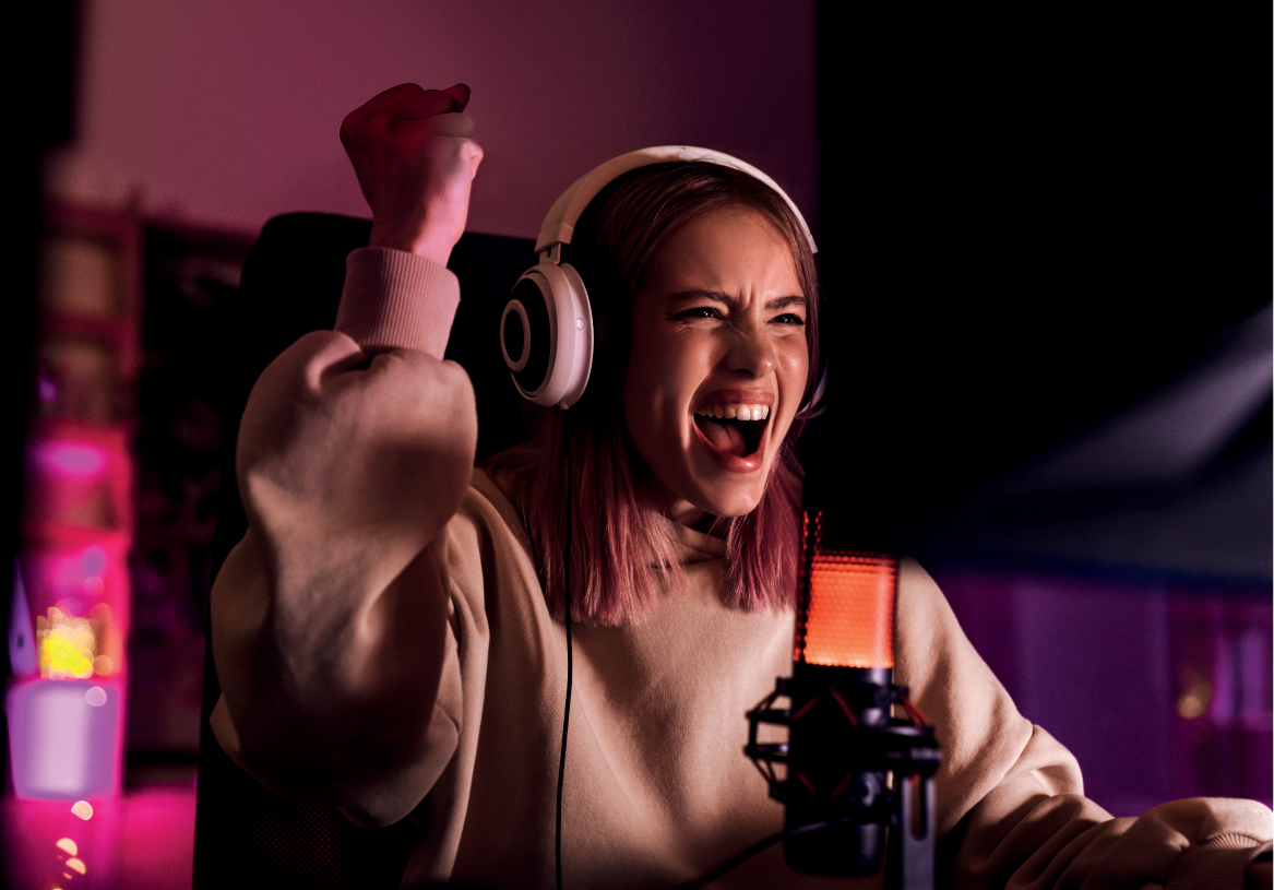 Girl playing video games on EK Fluid Gaming PC. Visit the EK booth at PAX West for a fully liquid-cooled gaming experience.